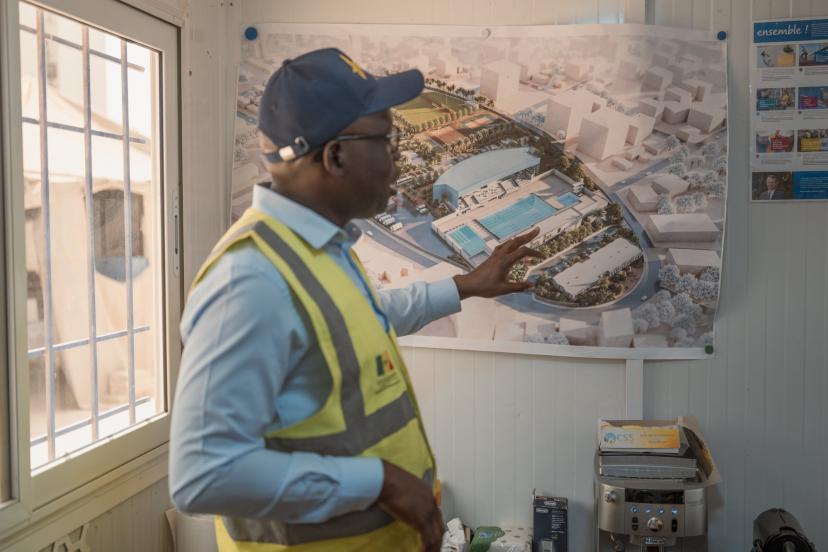 Babacar Senghor, coordinator of the Dakar 2026 Youth Olympic Games project, reviewing pool blueprints