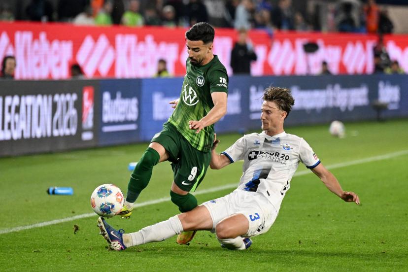 Wolfsburg players in action against Paderborn during the Bundesliga relegation playoff first leg