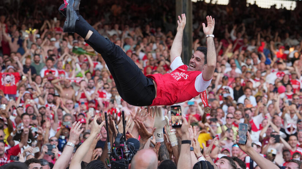 Arsenal manager Mikel Arteta is carried by players celebrating their Premier League title after the match between Crystal Palace and Arsenal in London, England, on Sunday, May 24, 2026.