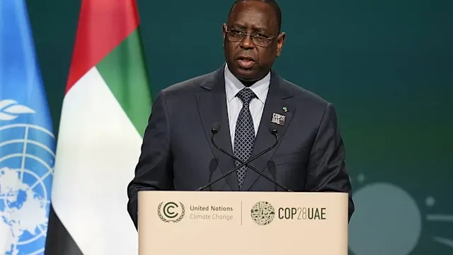 Macky Sall and Diomaye Faye shaking hands during a formal meeting