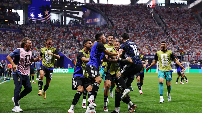 Soccer players celebrating a goal in a tightly contested match