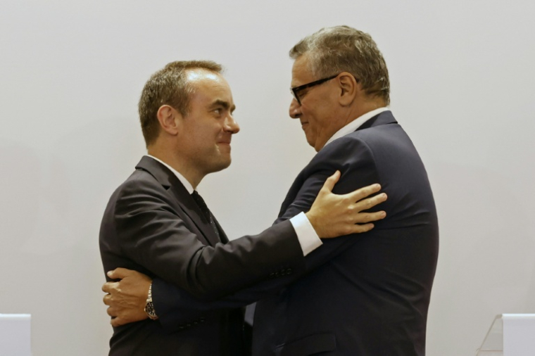 French and Moroccan leaders embrace after a press conference in Rabat