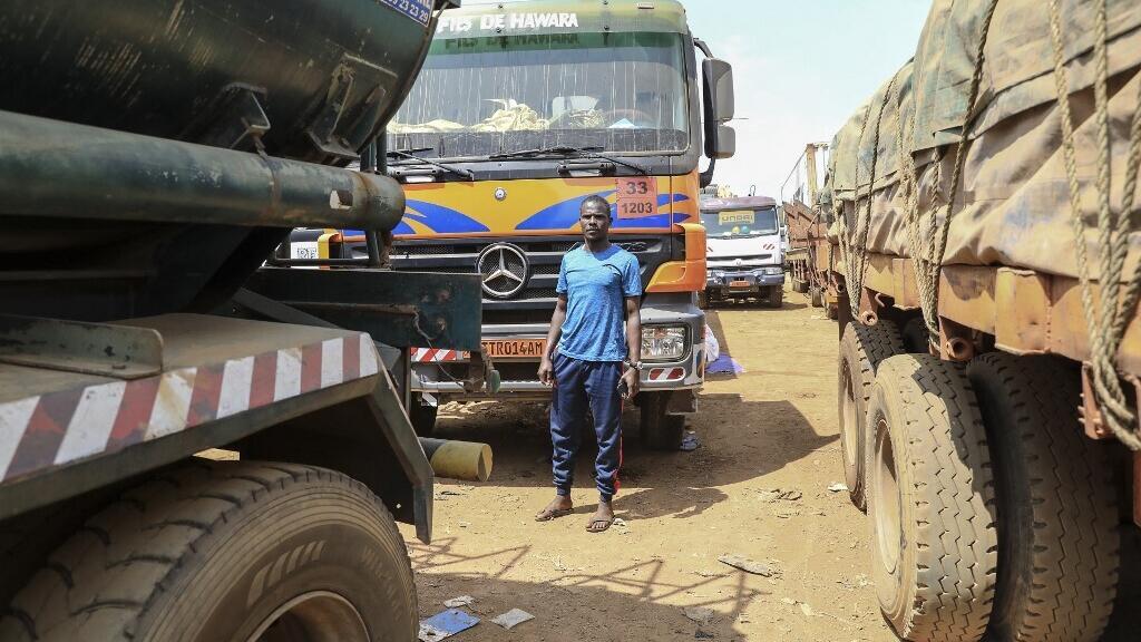 Trucks waiting on the main road connecting Bangui in the Central African Republic to Douala in Cameroon