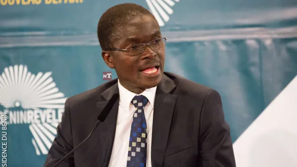 Lazare Sehouéto speaking at a podium in Cotonou