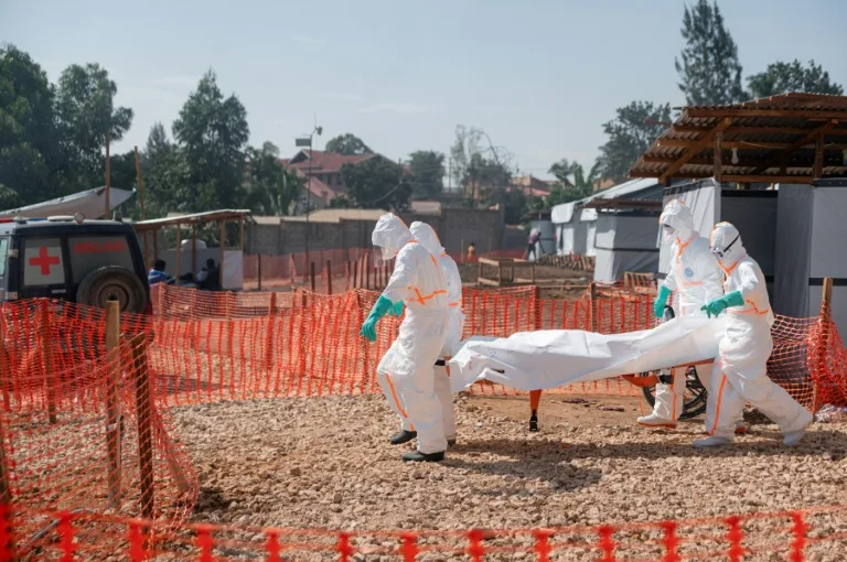 Health workers in protective gear treating Ebola patients in a treatment center